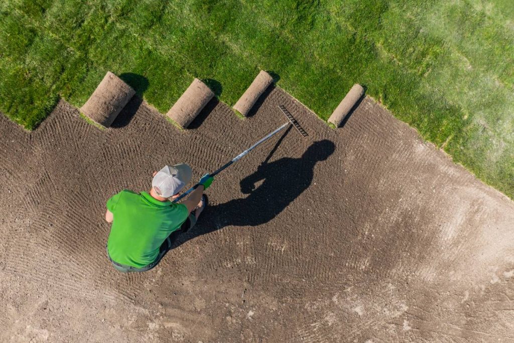 Man Installing Grass Turfs on a Golf Course Aerial View.
